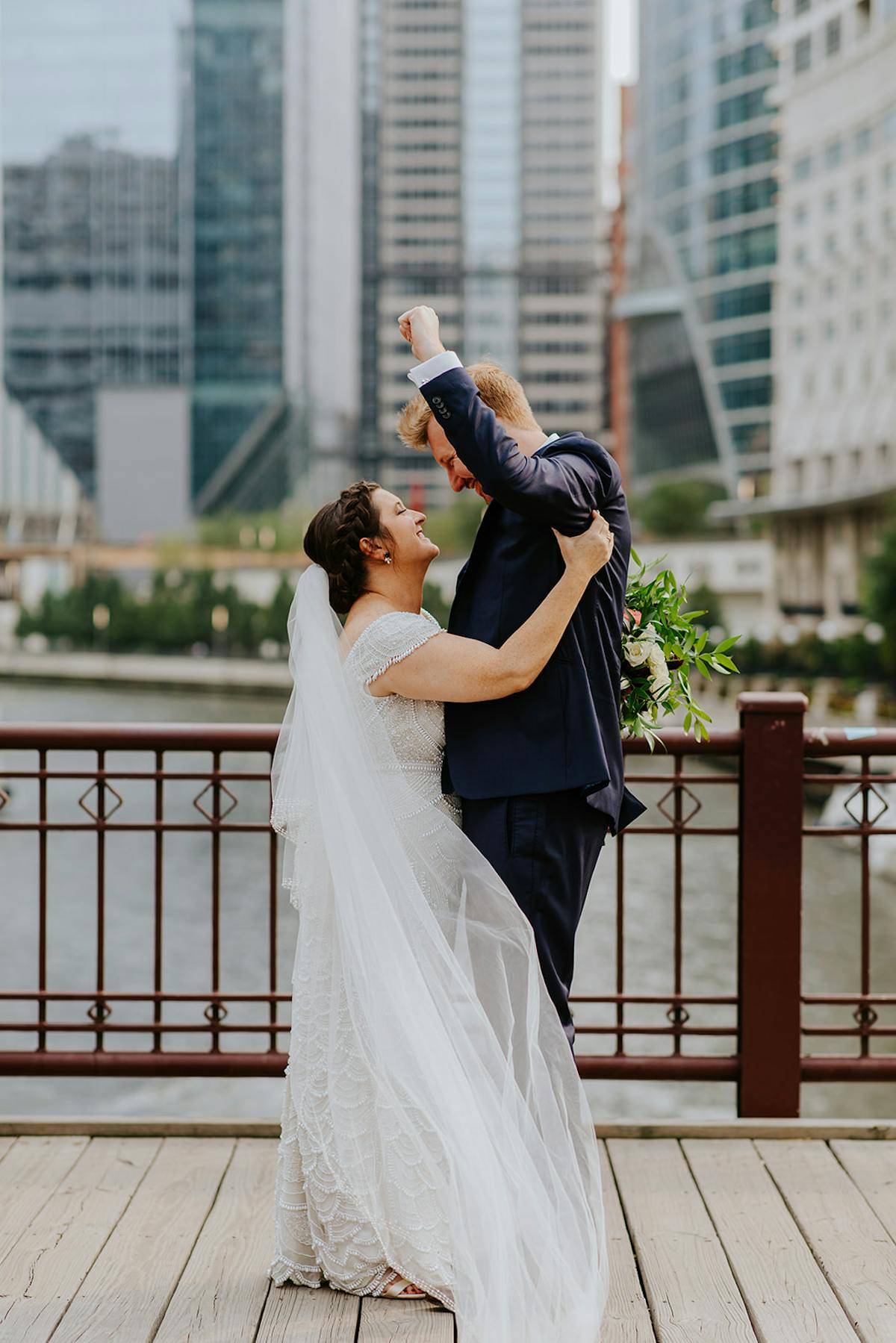 a woman standing in front of a building talking on a cell phone