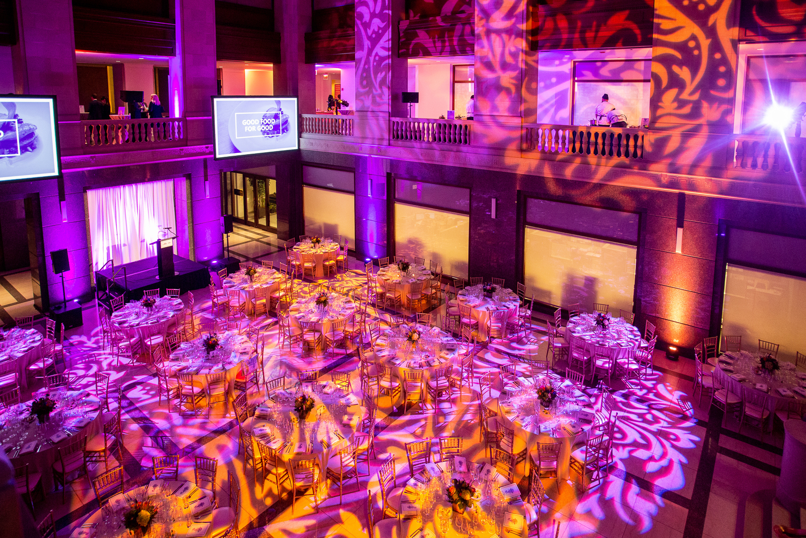 a bunch of vegetables on display lit up at night