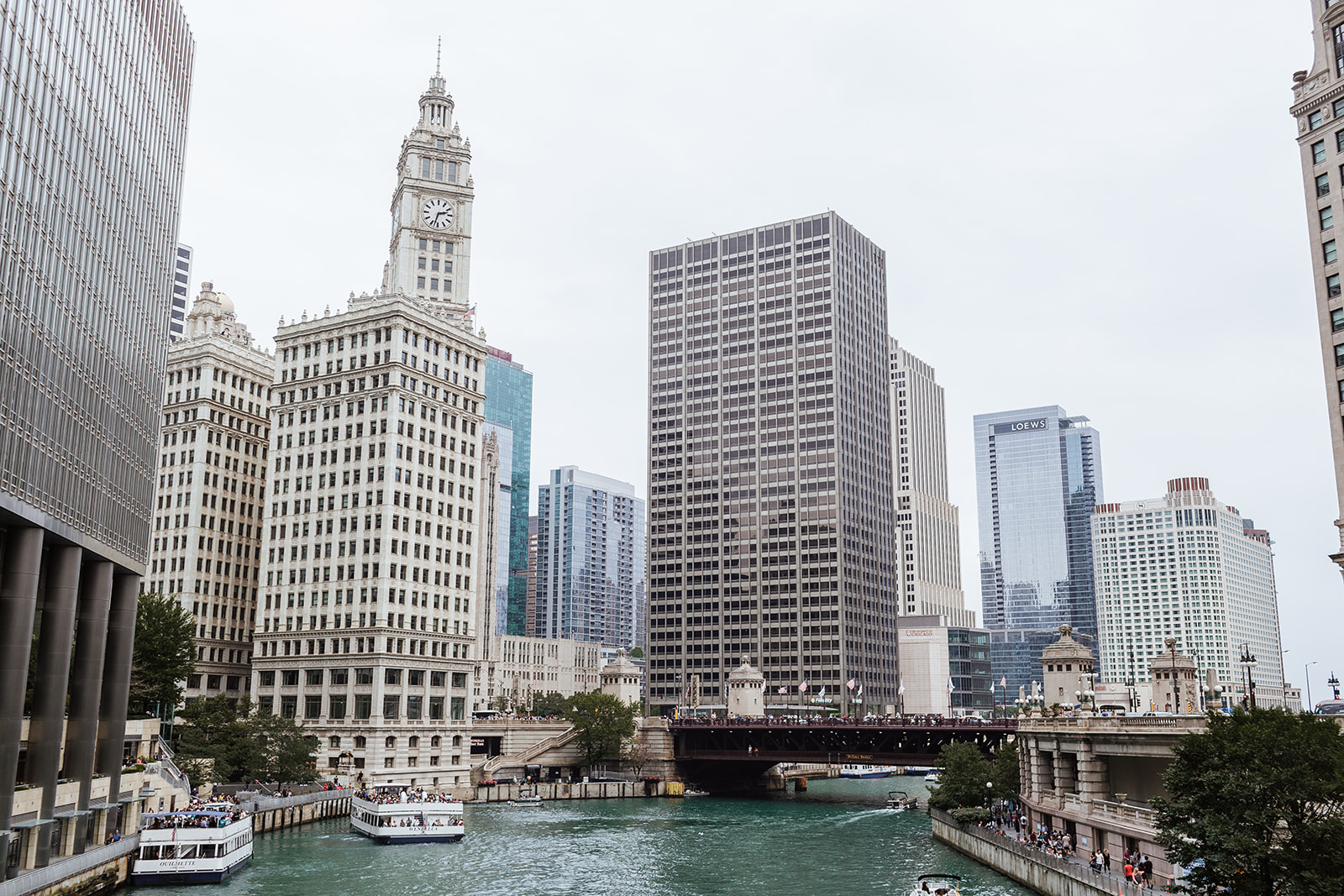 a bridge over water with a city in the background