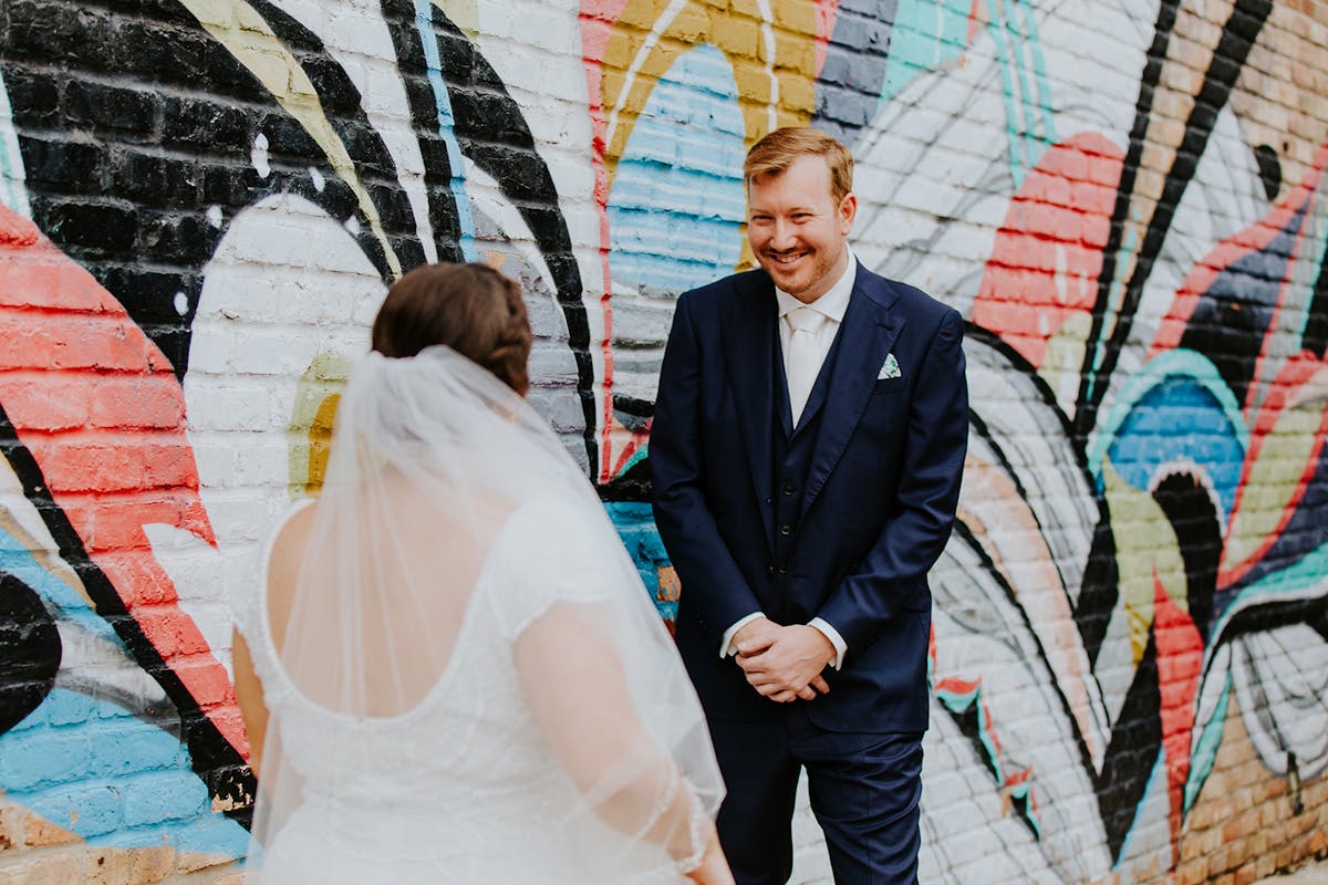 a man and a woman standing in front of a building