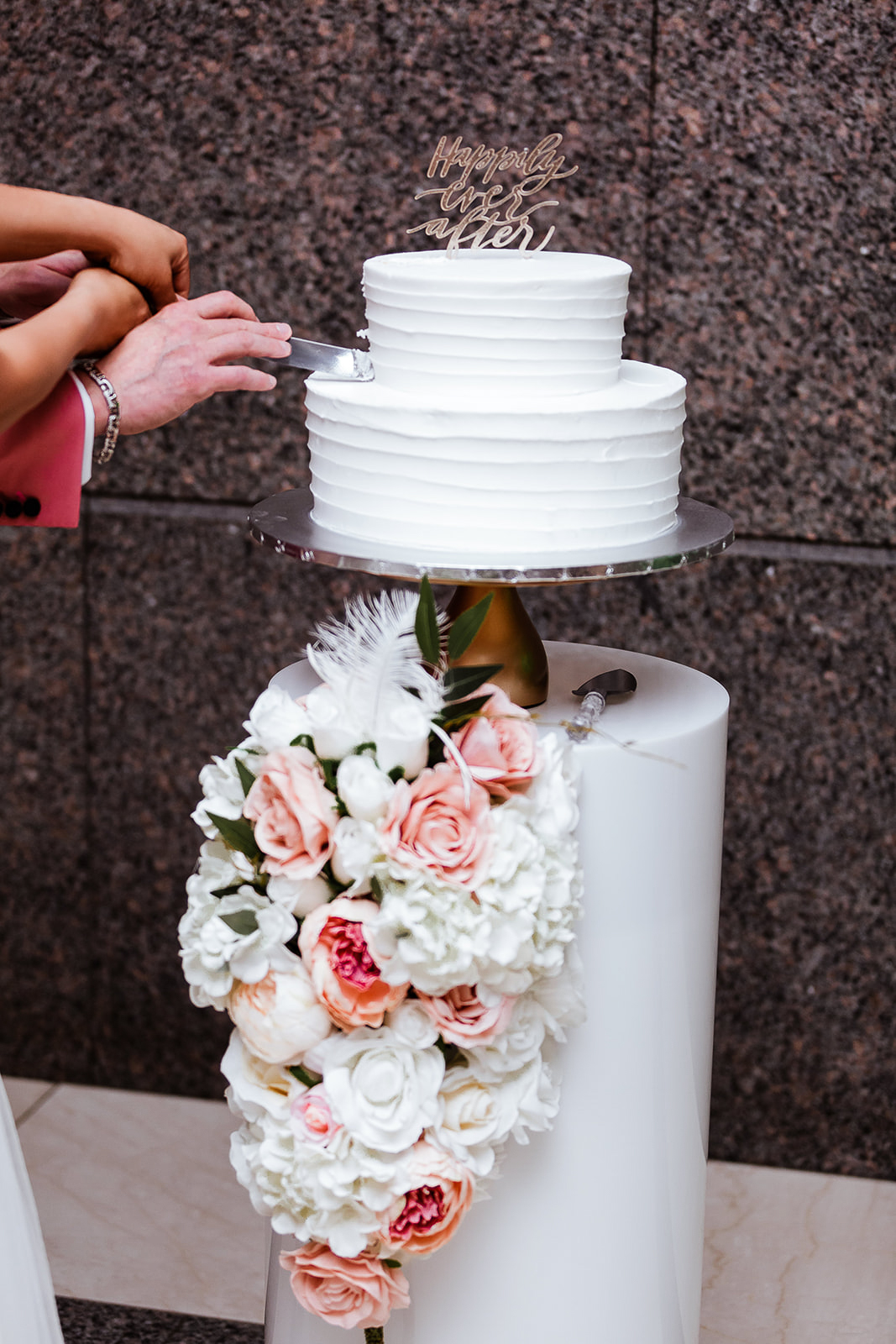 a woman cutting a wedding cake