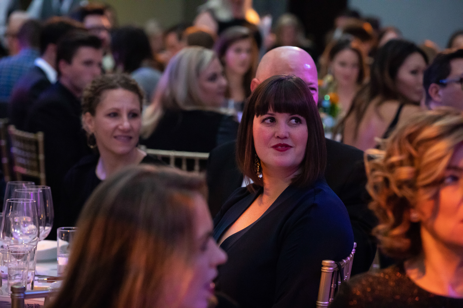 a crowd of people holding wine glasses