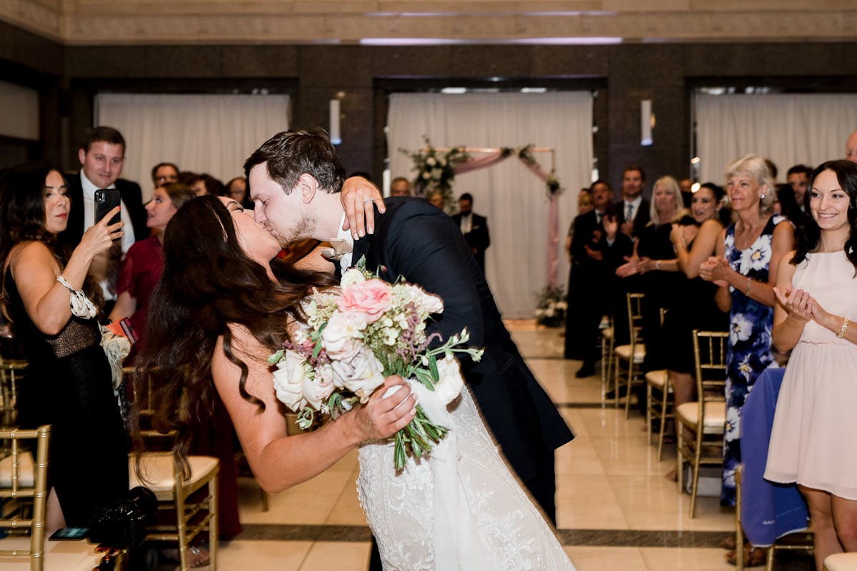Groom kissing and dipping a bride at A Timeless Classic Historical Chicago Wedding Venue