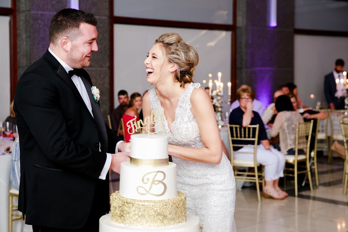 a person standing in front of a wedding cake