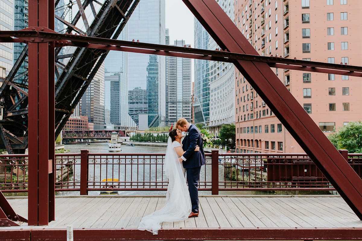 a man standing in front of a bridge