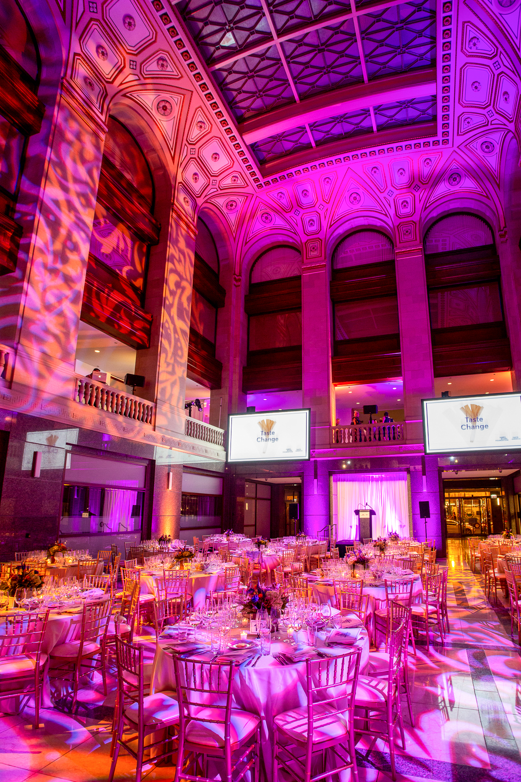a group of people on a stage in front of a building