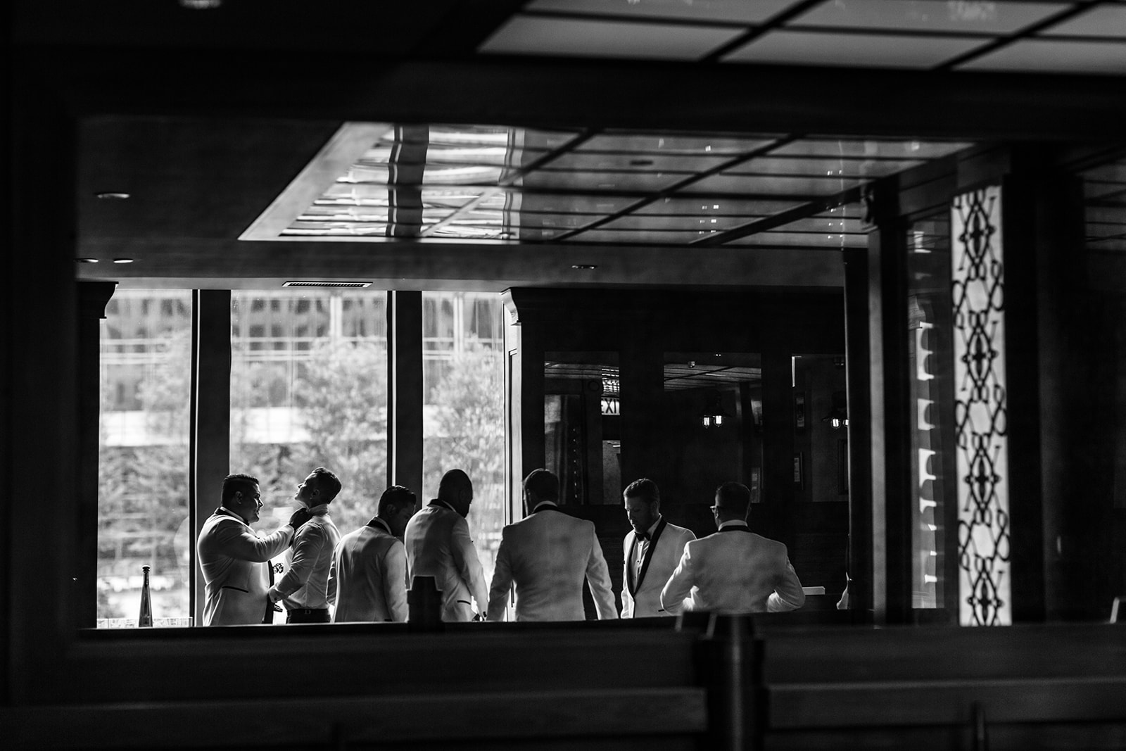 a group of people sitting in front of a window
