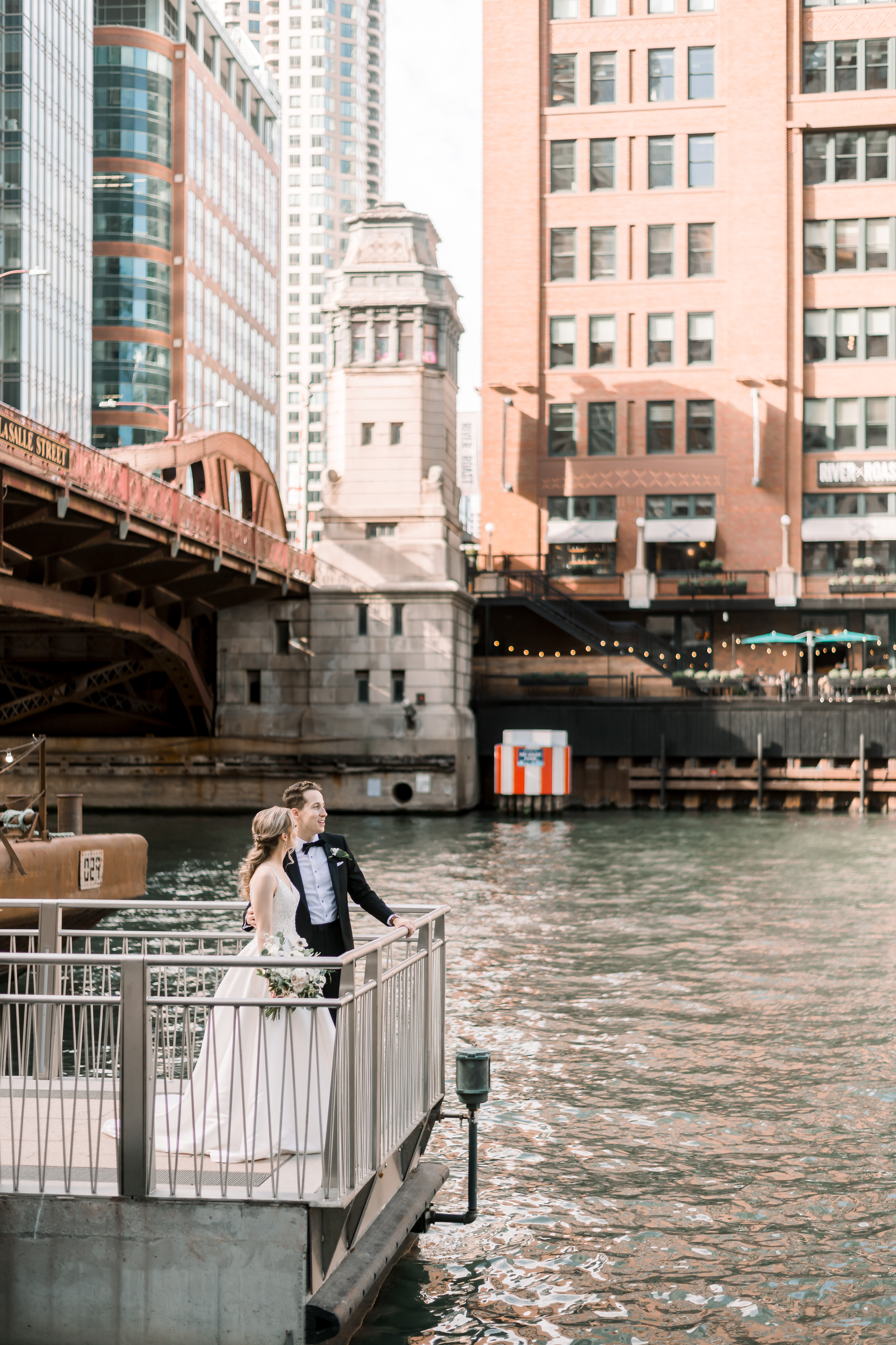 a bridge over water with a city in the background