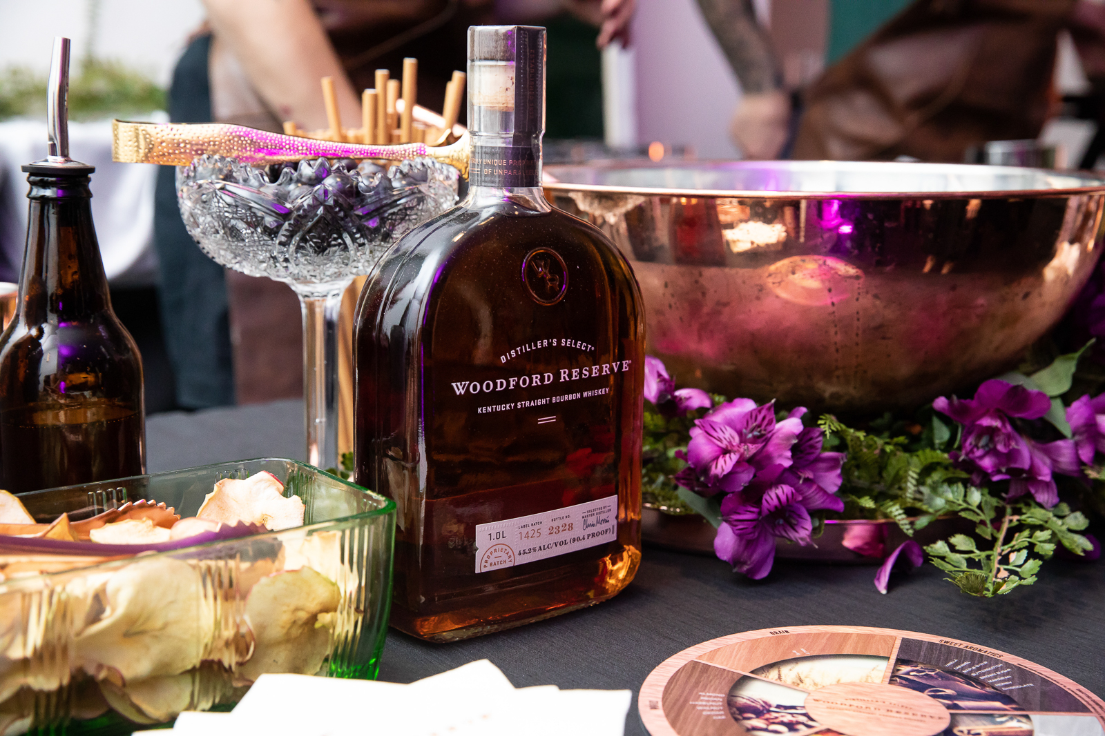 a person sitting at a table with a glass of wine