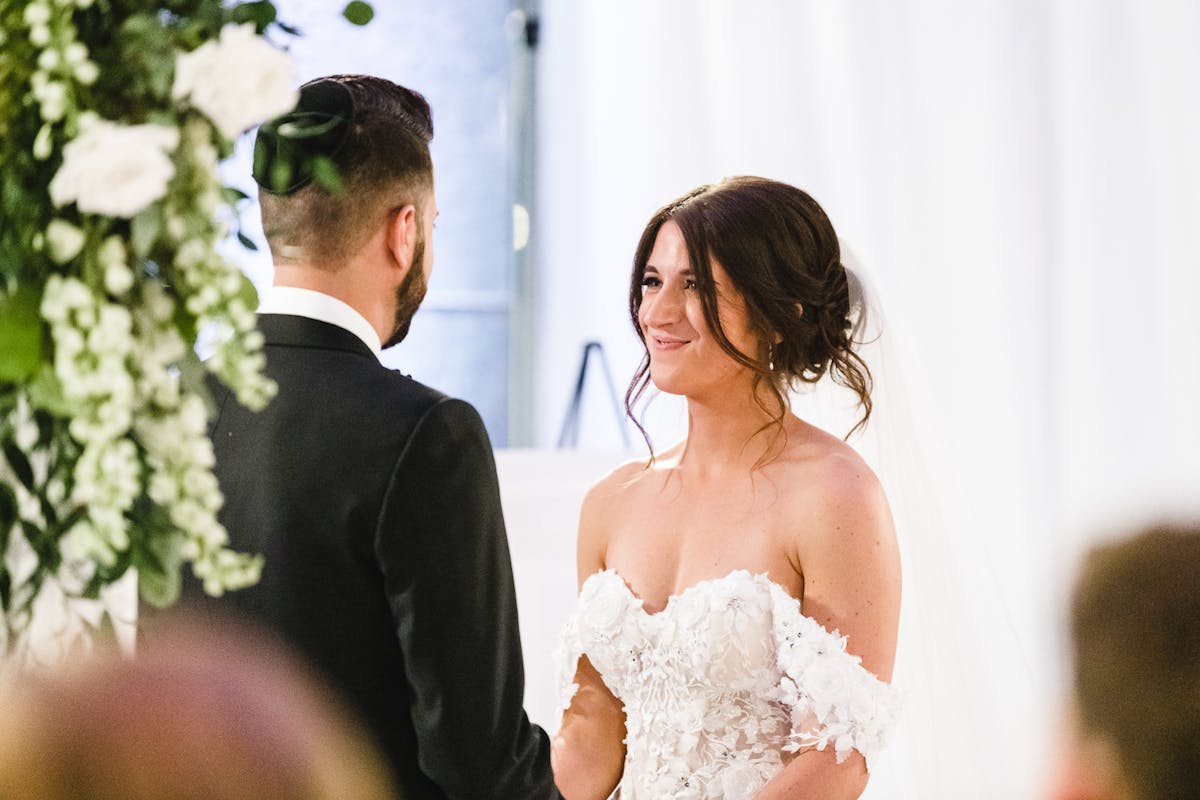 a person standing in front of a wedding cake