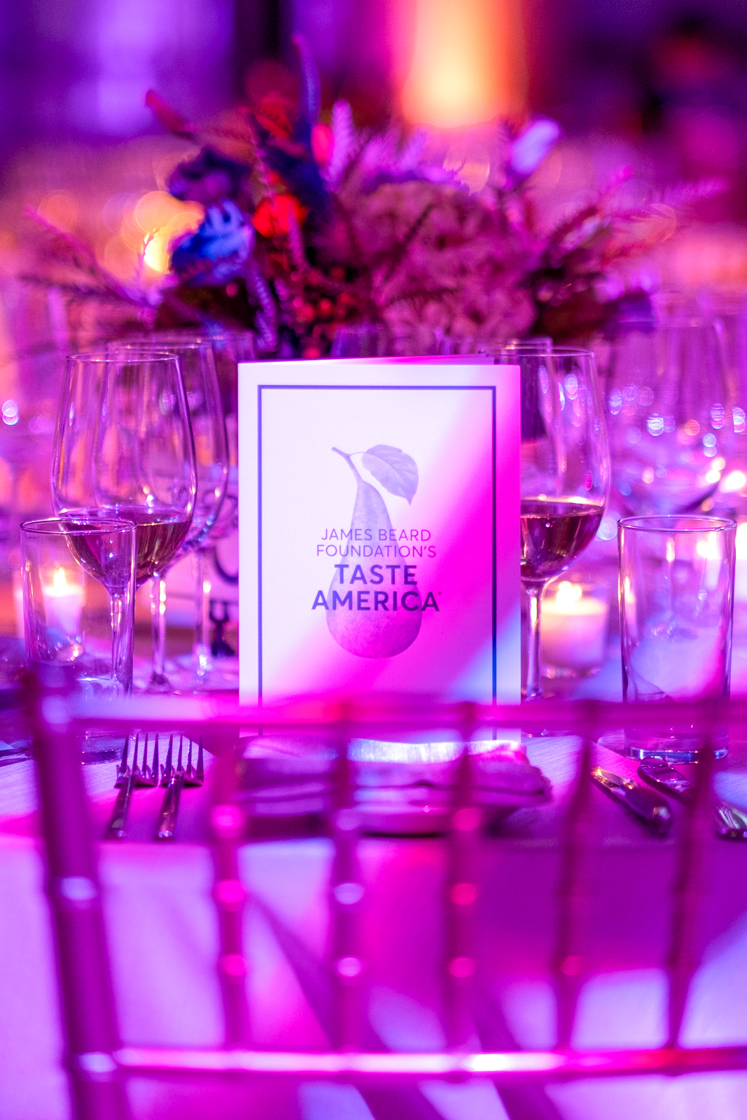 a bunch of vegetables on display lit up at night