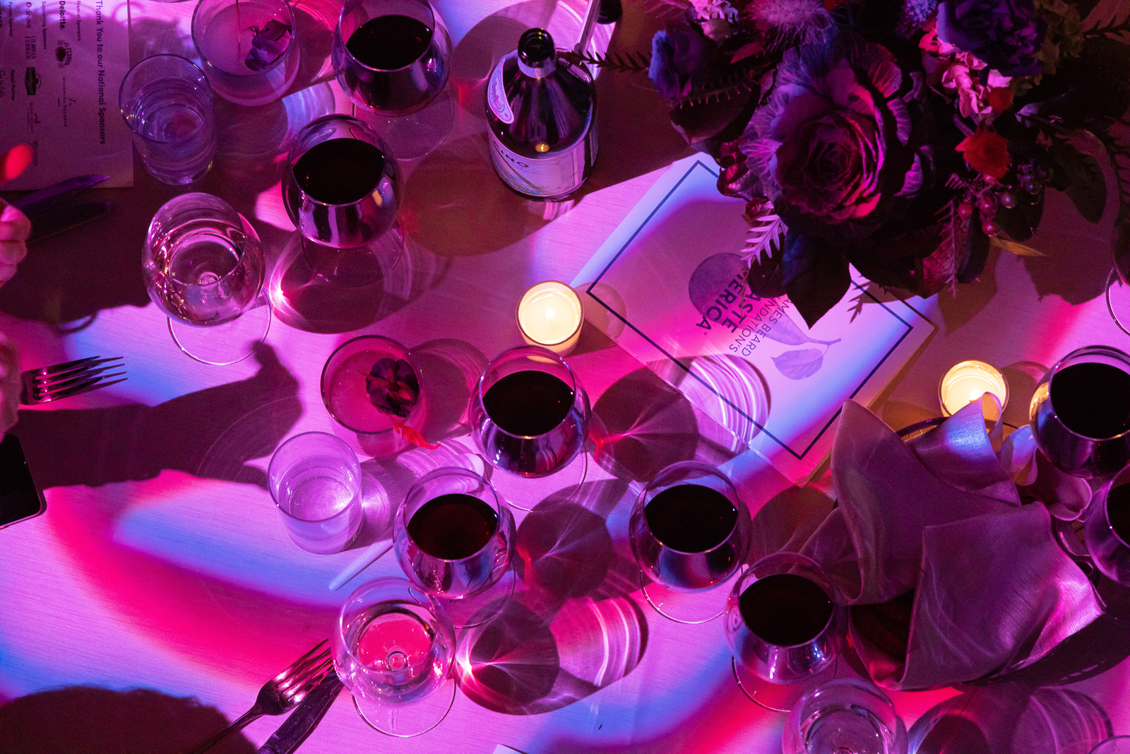 a group of people sitting at a table with wine glasses