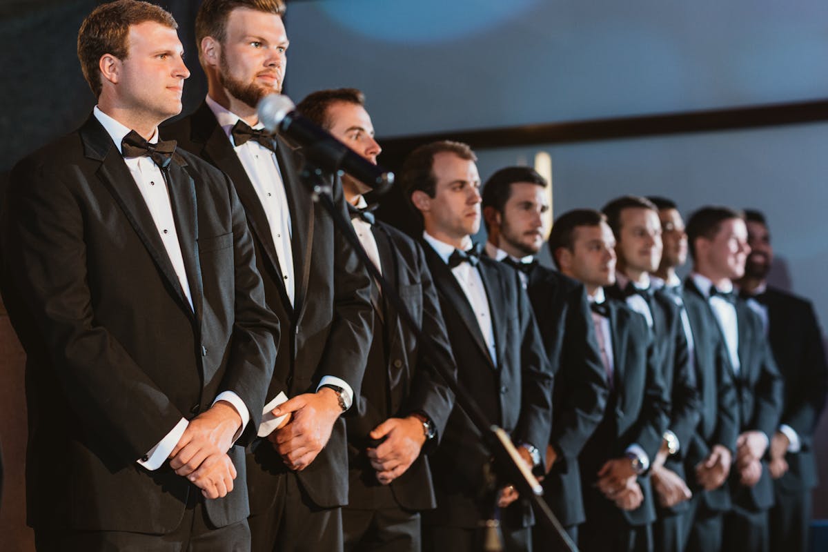 Marian Cozma et al. standing next to a man in a suit and tie