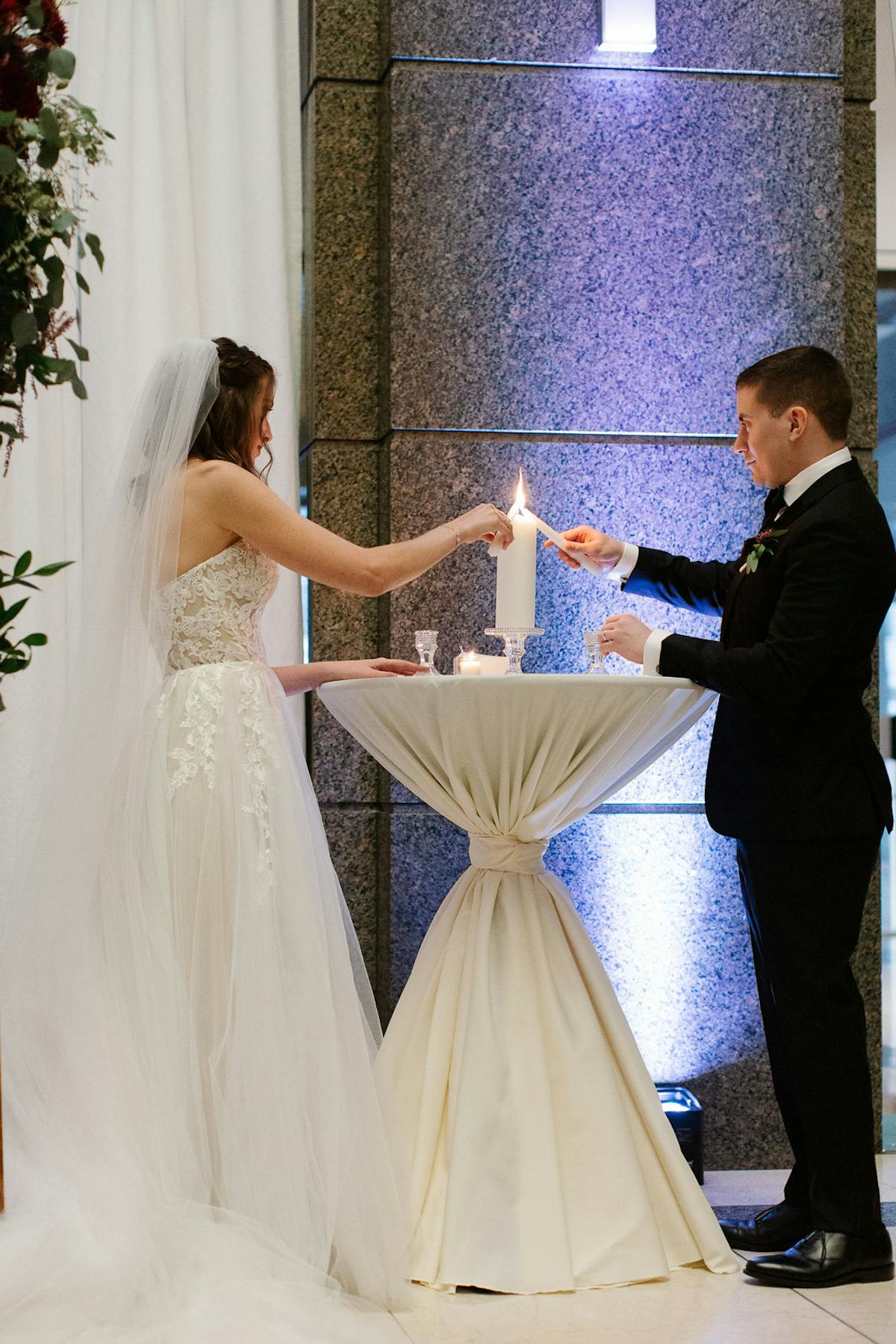 a man standing next to a woman in a wedding dress