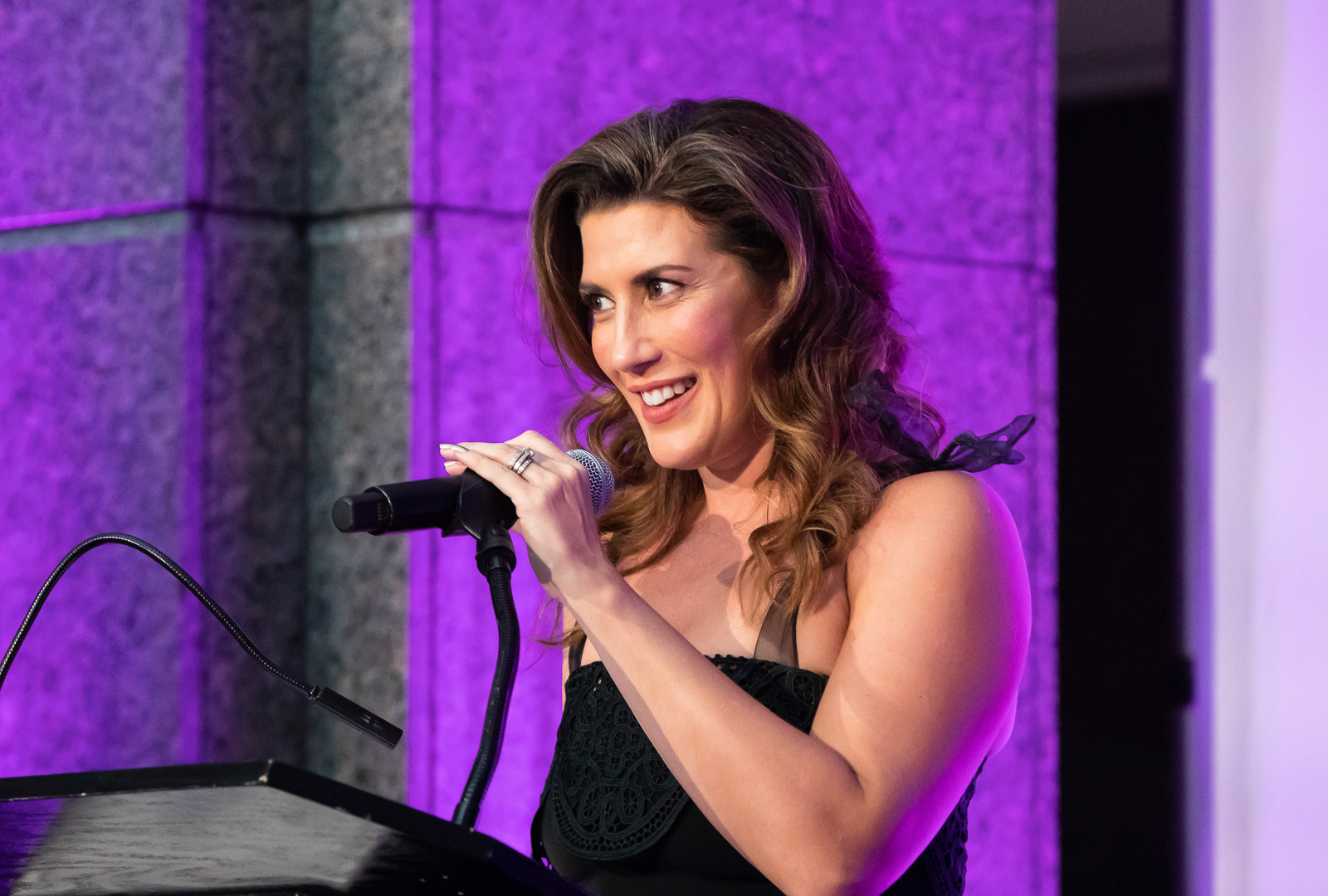 a woman with purple hair using a cell phone