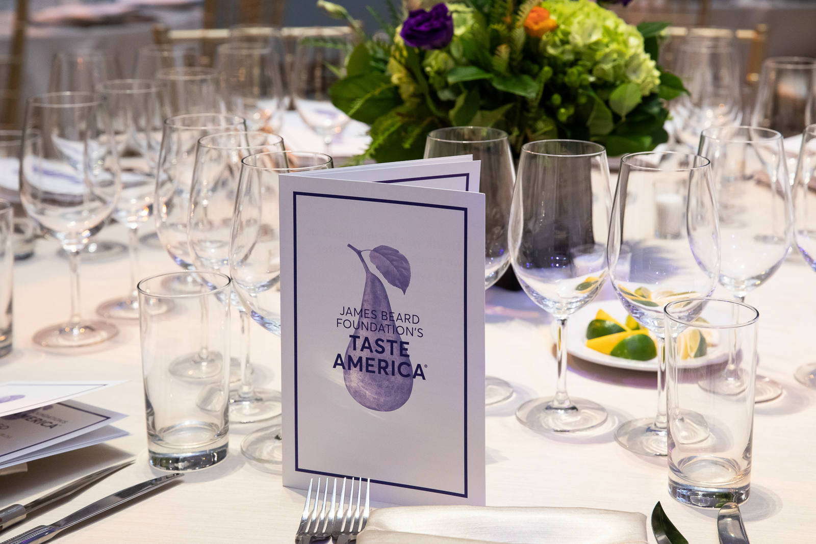 a group of people sitting at a table with wine glasses