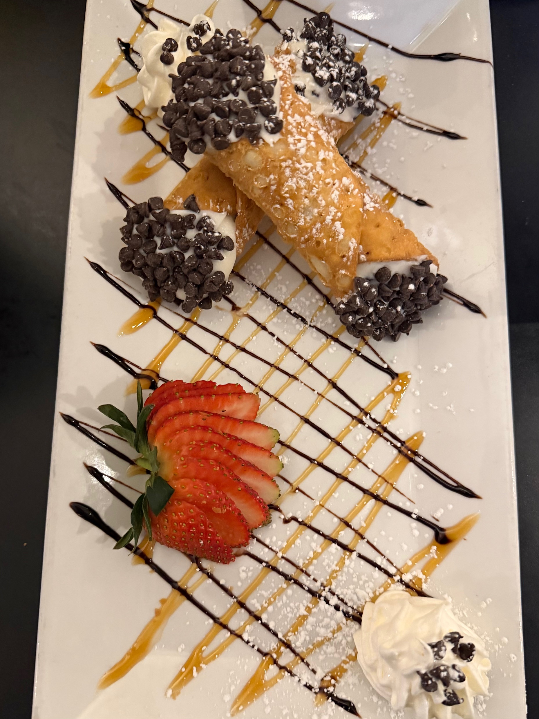 a plate of desserts with strawberries and chocolate chips