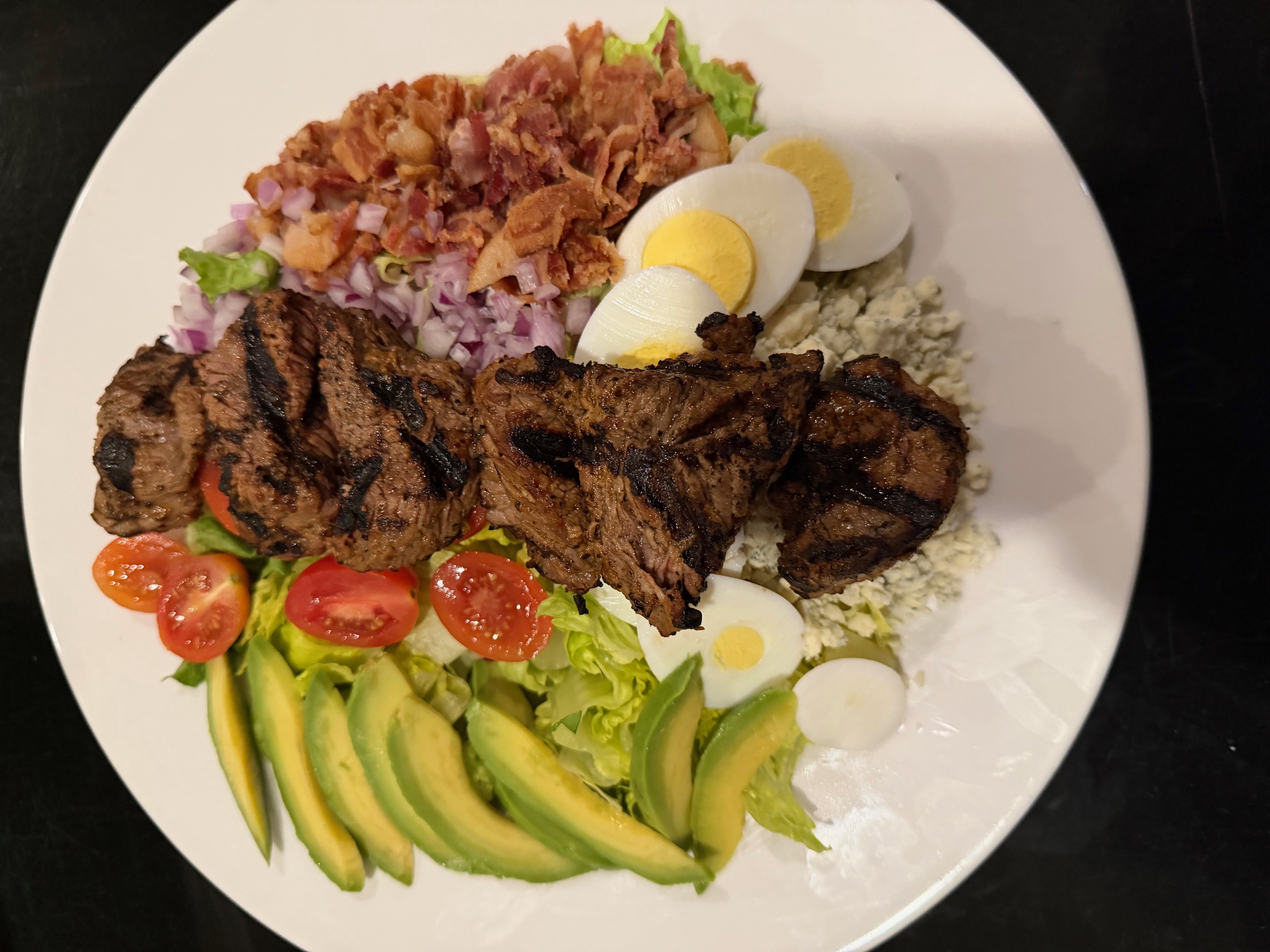 a plate of food on a black surface