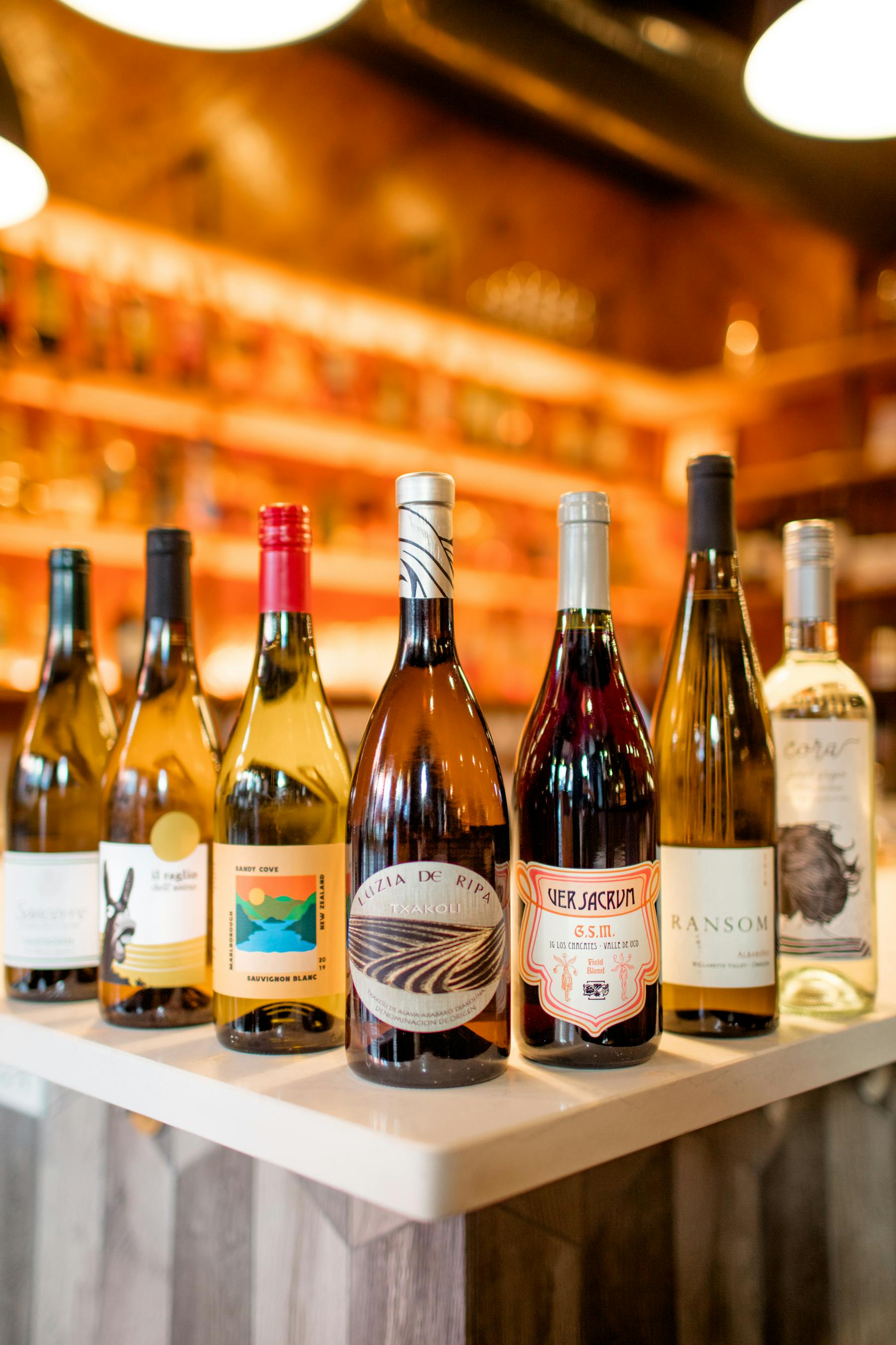 a bottle of wine and a glass of beer on a table