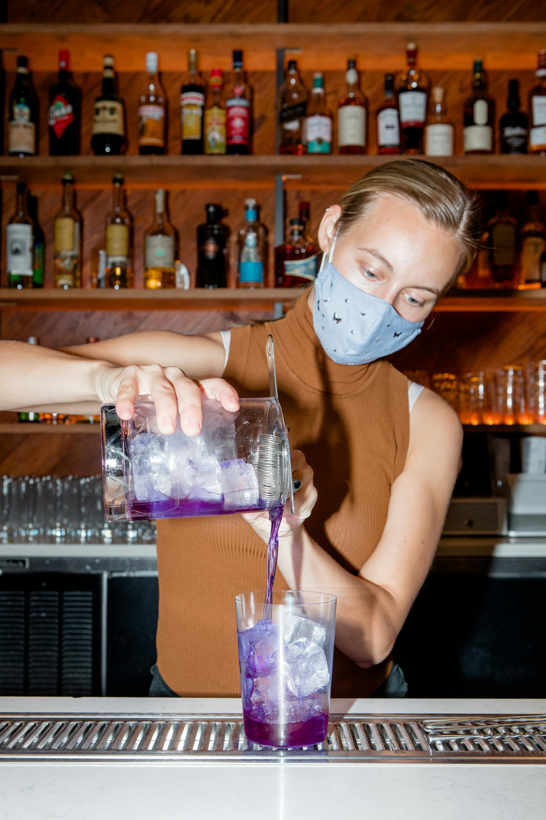 a person holding a bottle of beer on a table