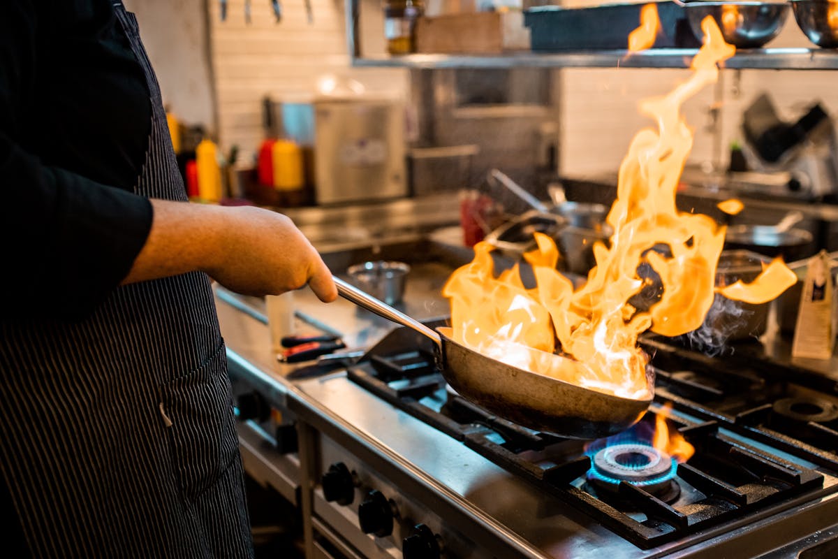 a person cooking in a kitchen preparing food