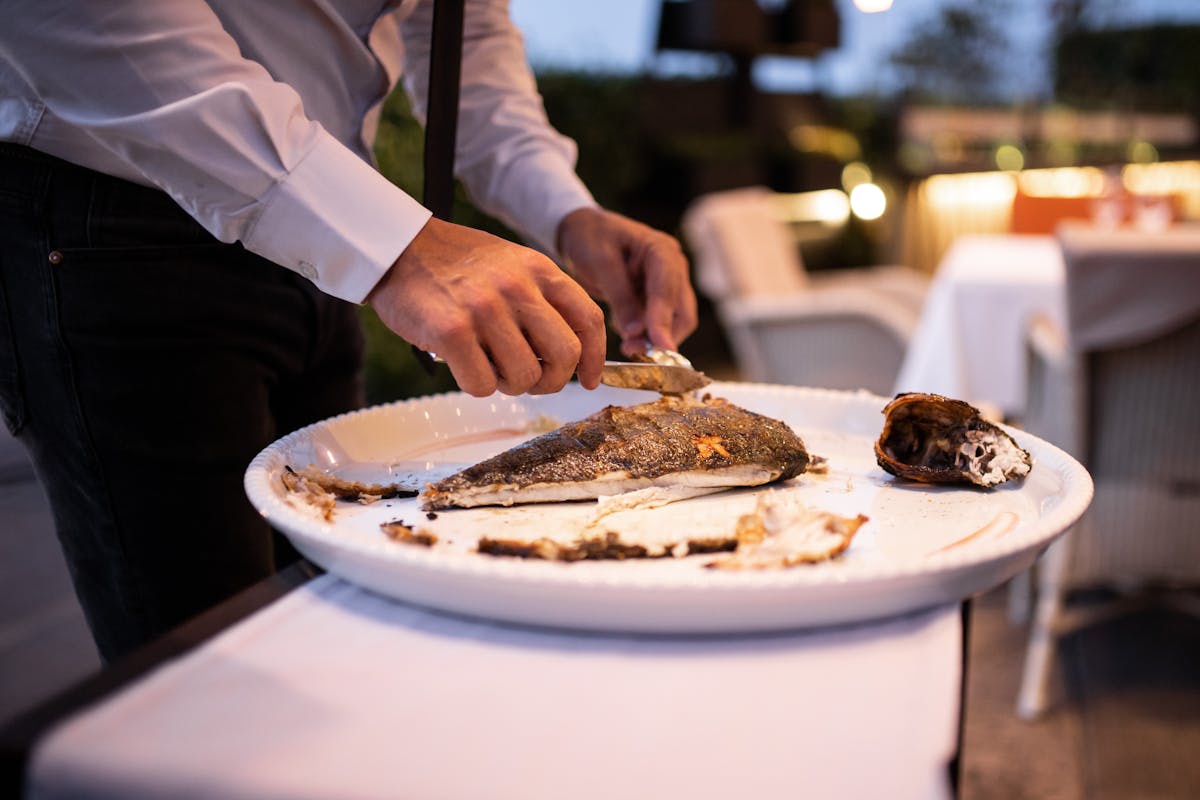 a person sitting at a table with a plate of food