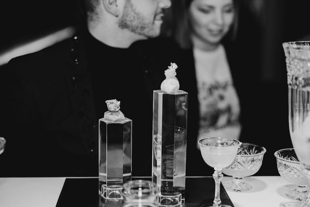 a person sitting at a table with wine glasses