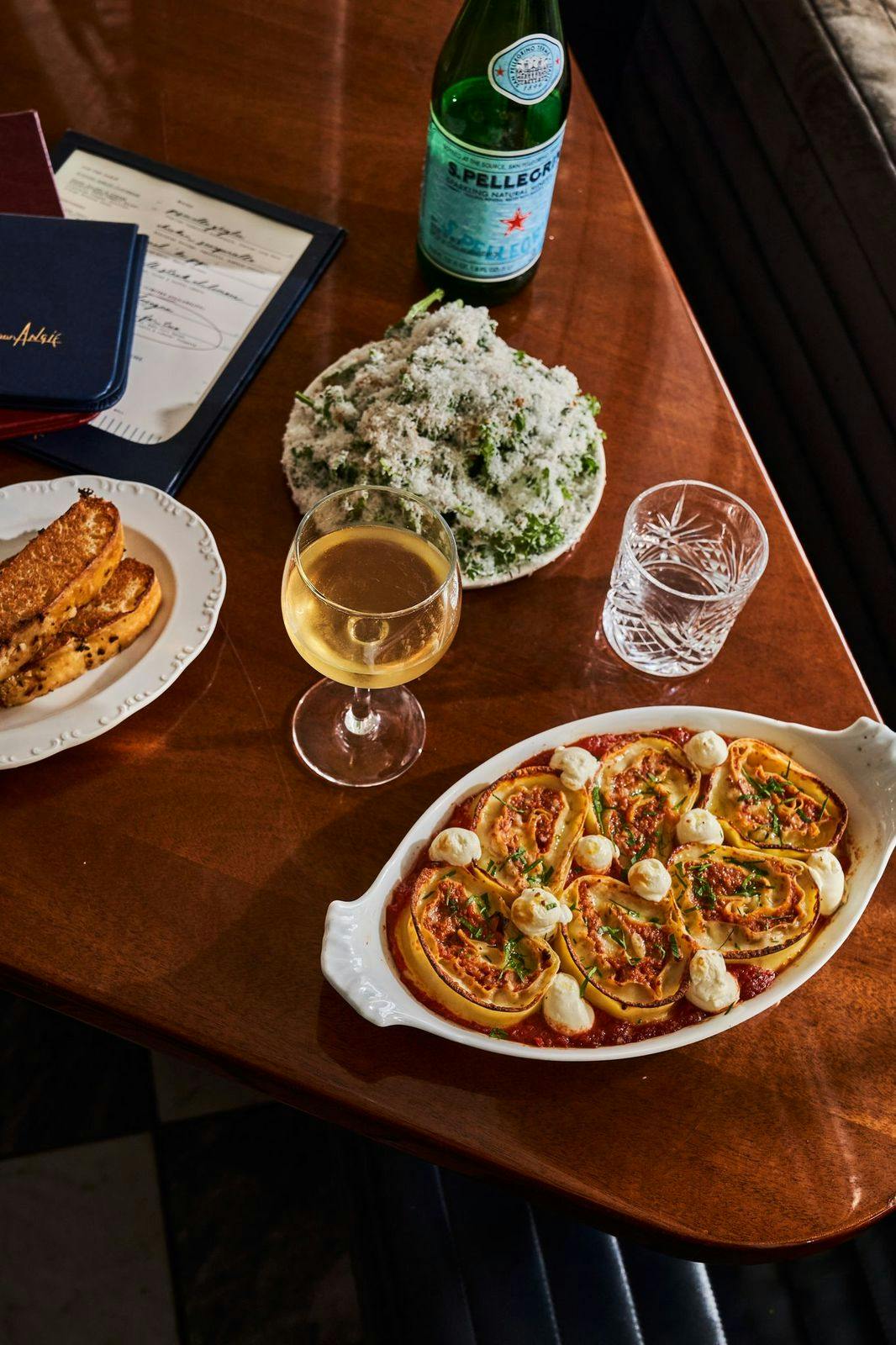 a wooden table topped with plates of food on a plate