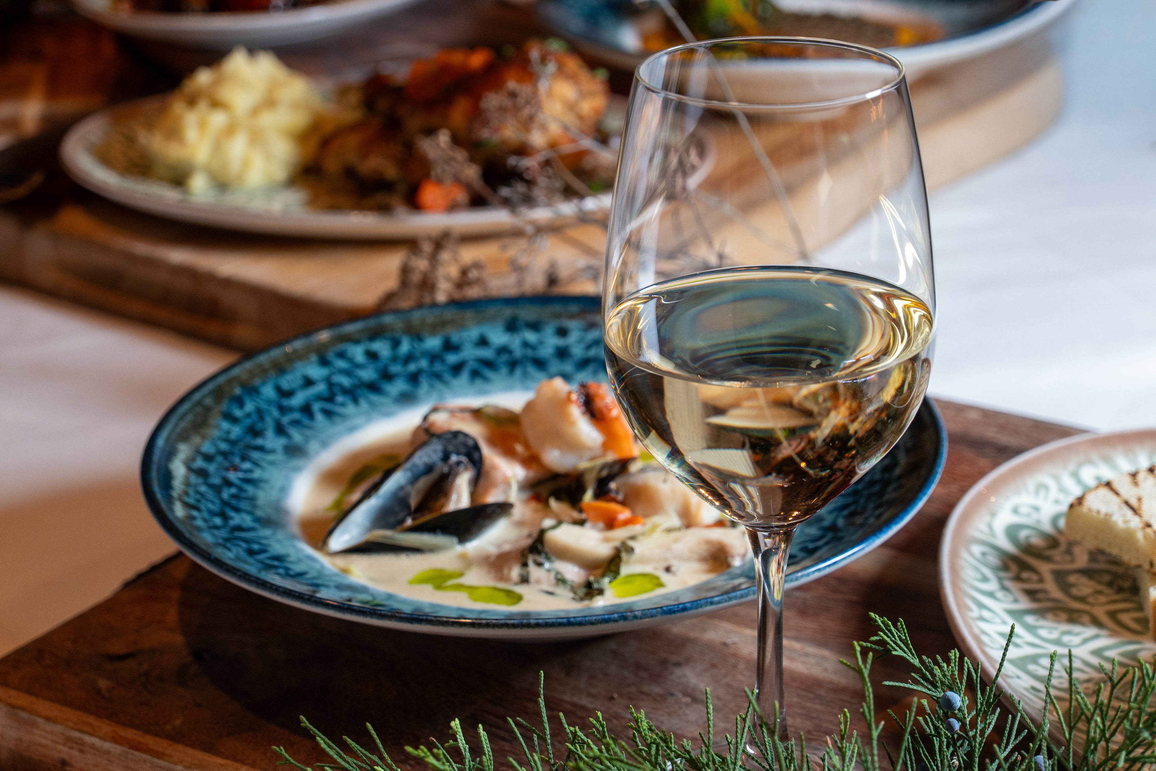 a glass of wine next to a plate of food