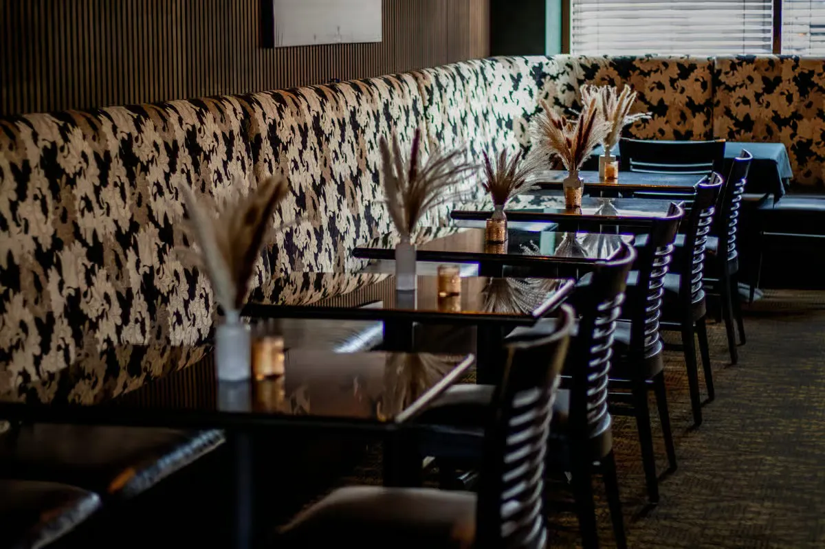a booth seating with tables and chairs