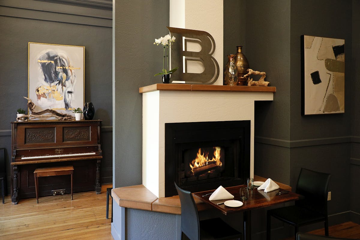 a living room filled with furniture and a fire place