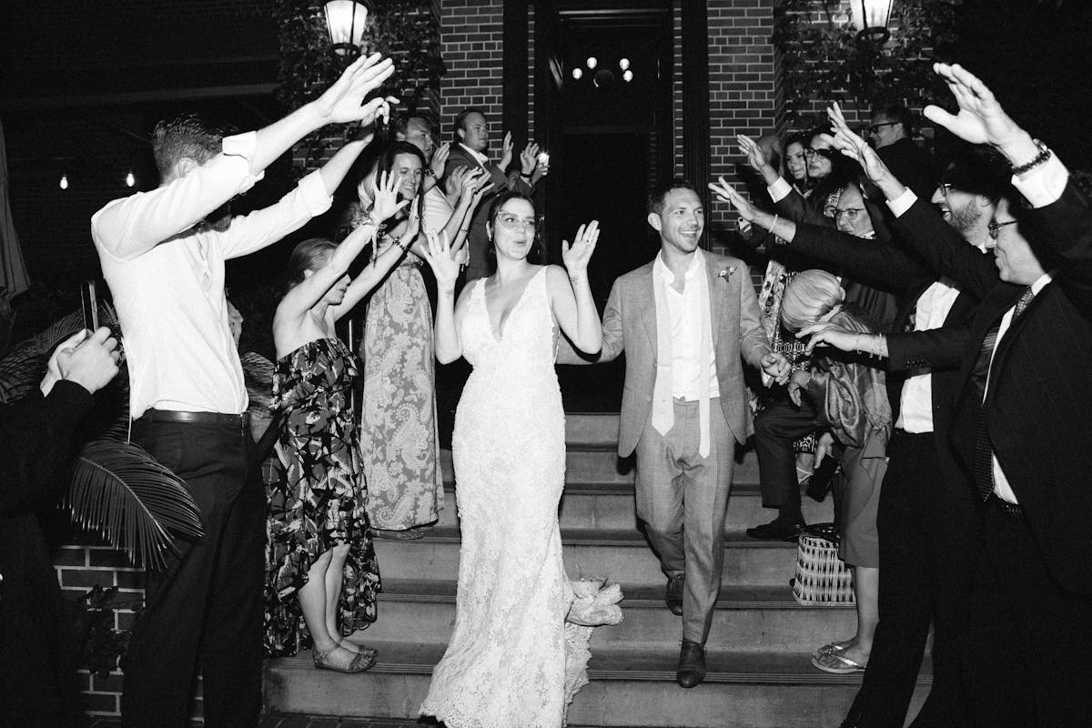 a bride and groom leaving the charter oak with guests surrounding and clapping