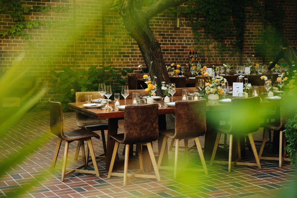 small table set with chairs and yellow flowers