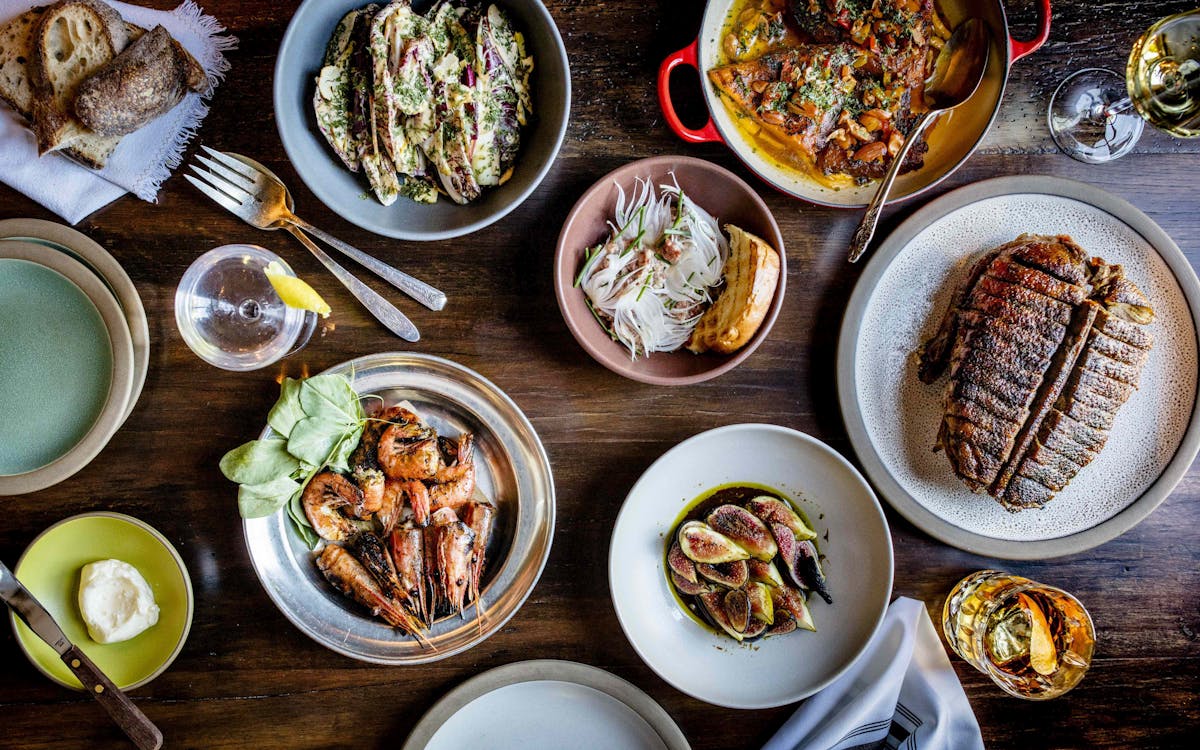 overhead shot of ceramic plates of charter oak food