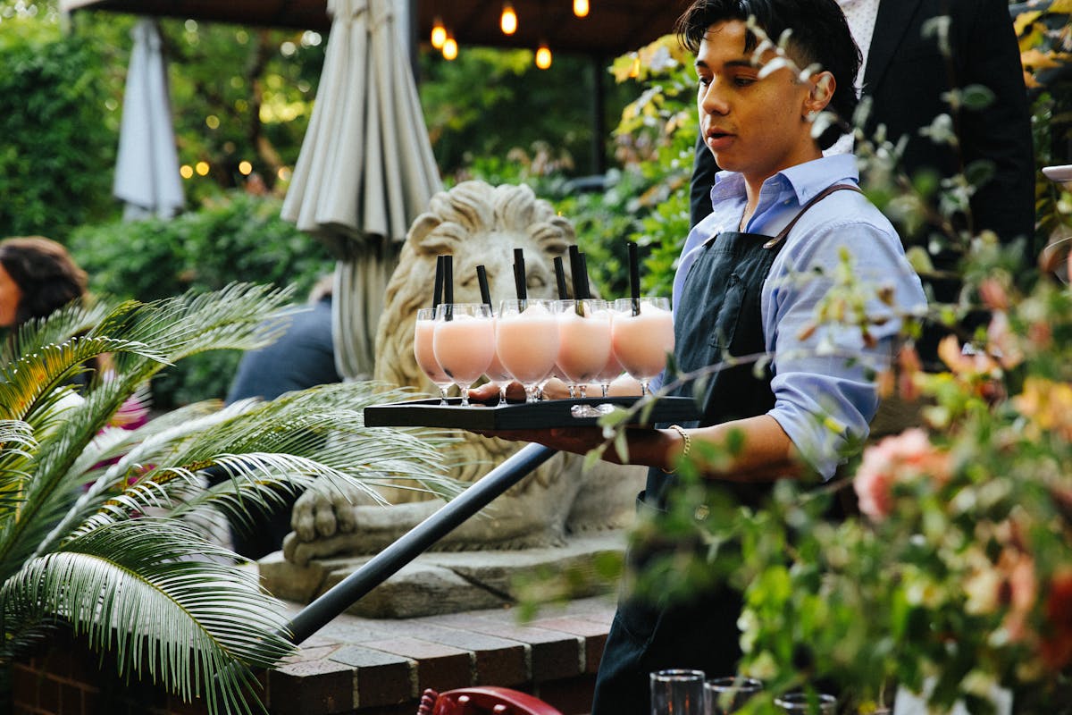 a server carrying a tray of charter oak cocktails