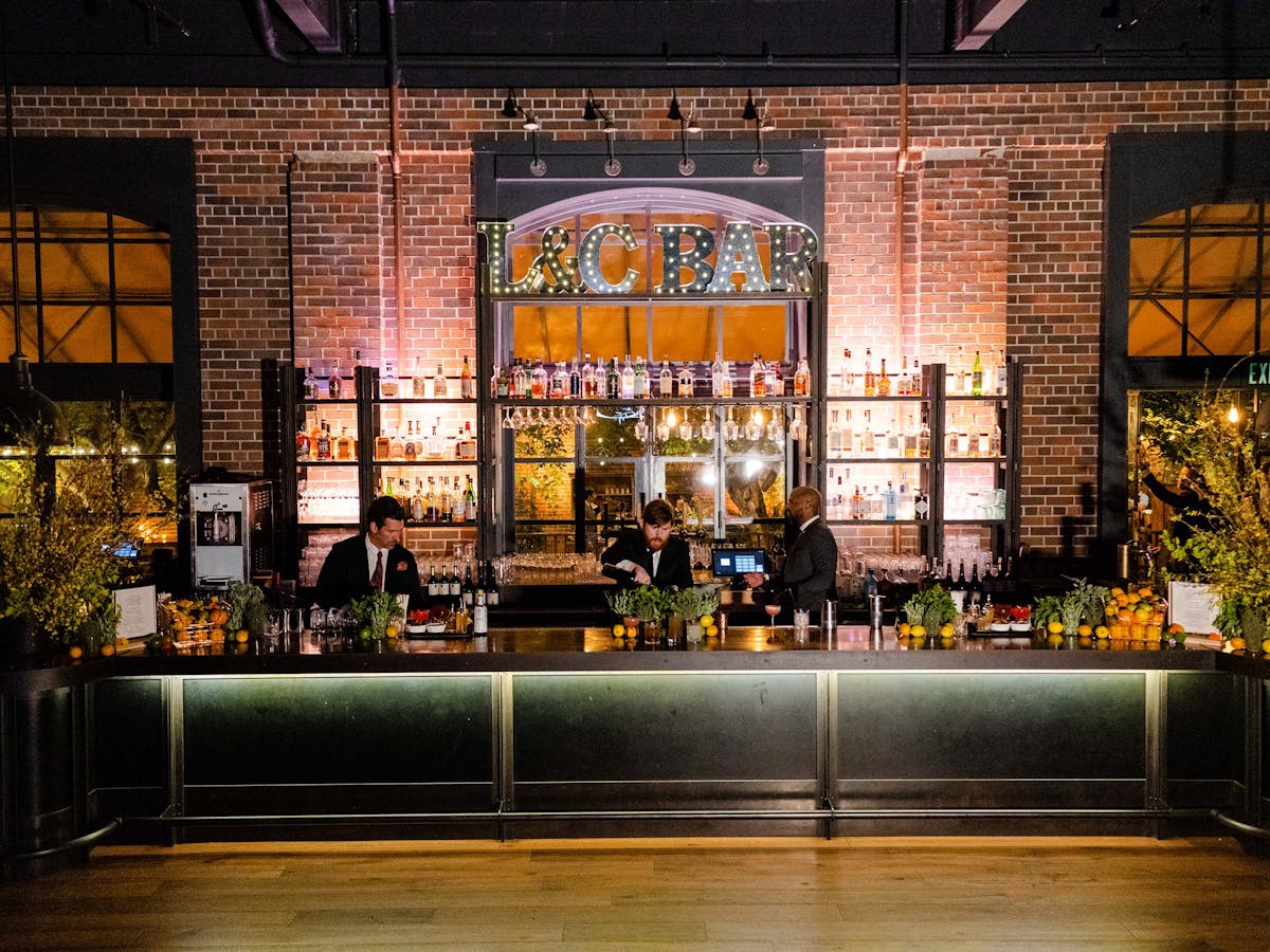 the charter oak bar with bartenders making drinks behind