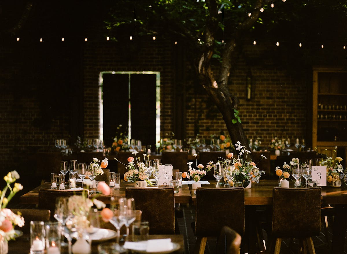 the charter oak courtyard set for a wedding with tables of flowers and candles