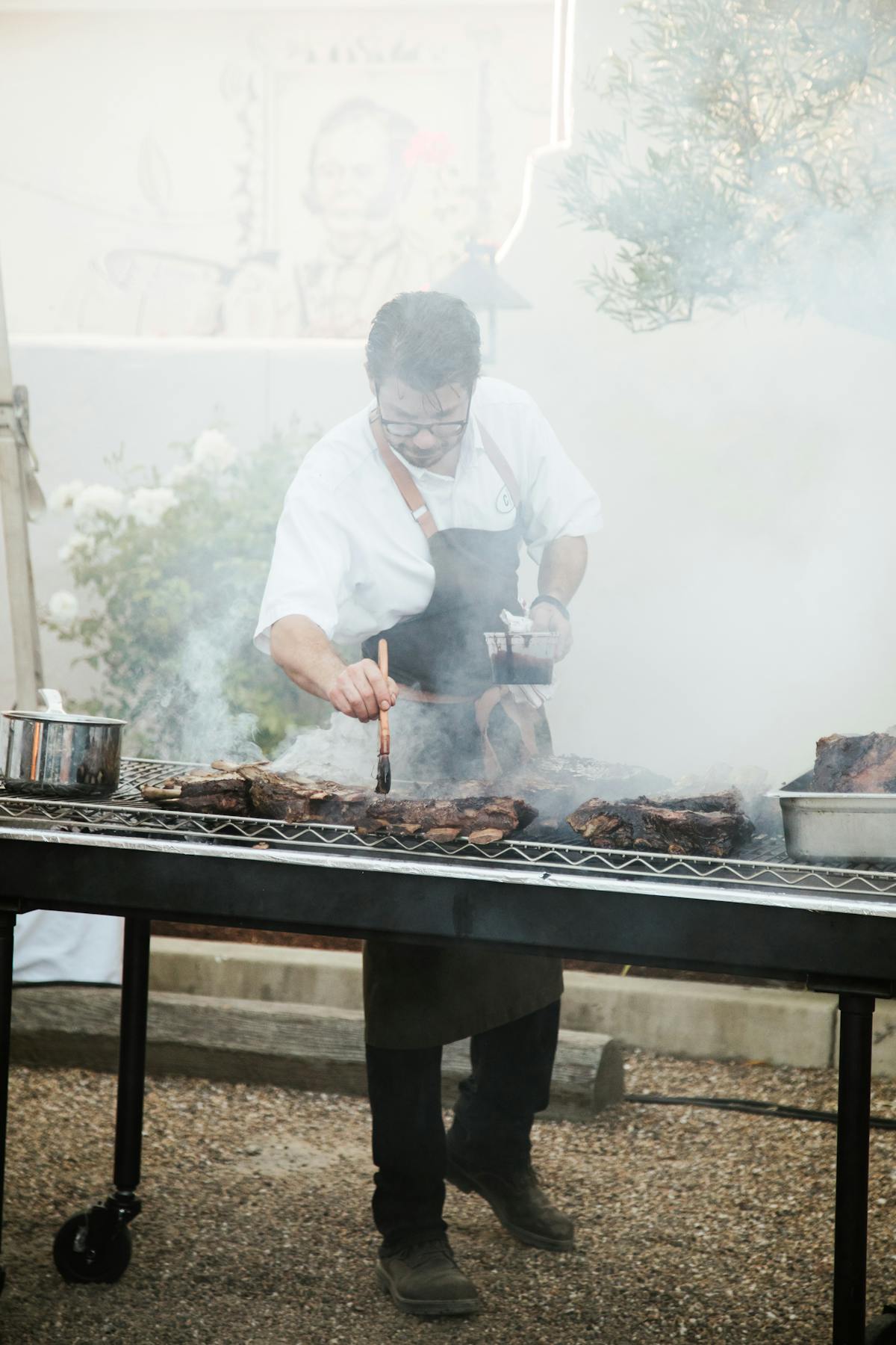 a man cooking food on a grill