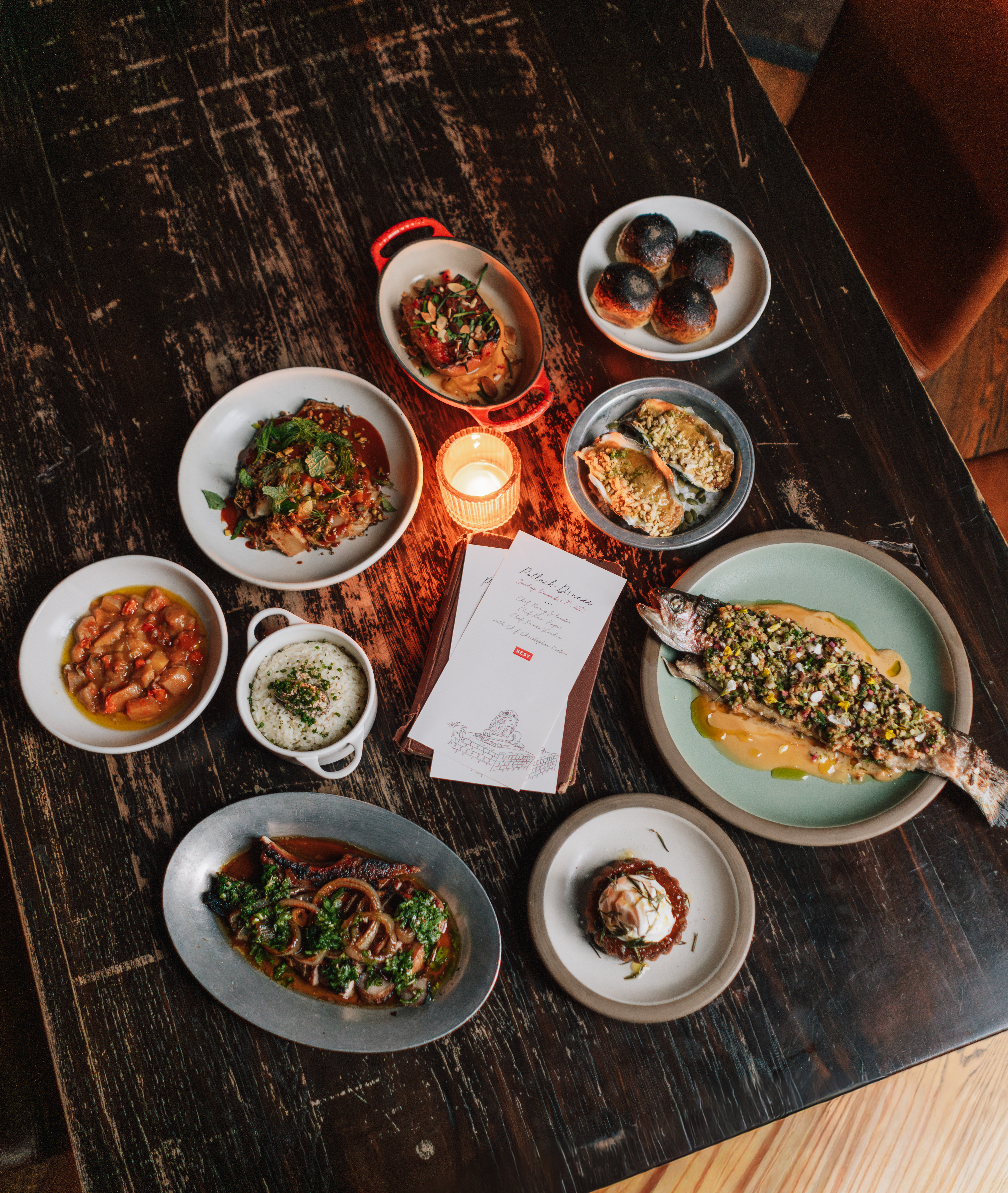 a table with plates of food and a candle