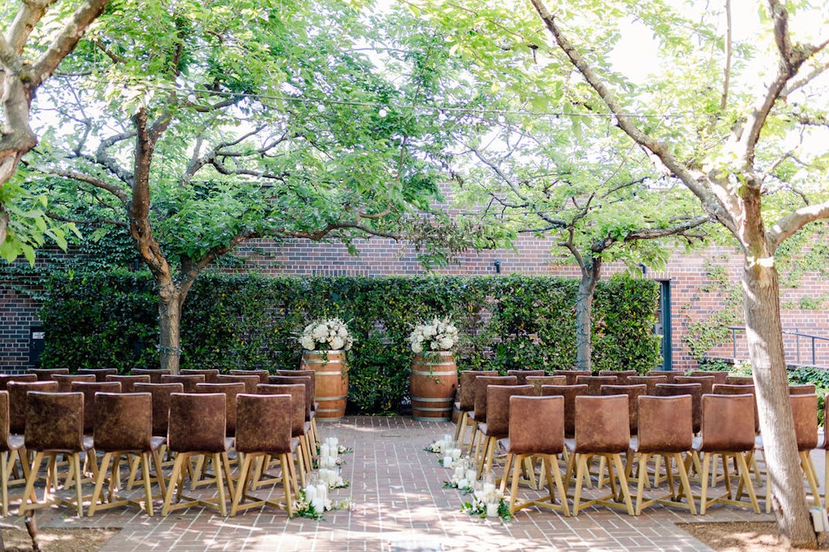a wooden bench sitting next to a tree