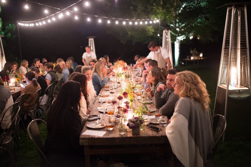 a group of people sitting at a table in a restaurant