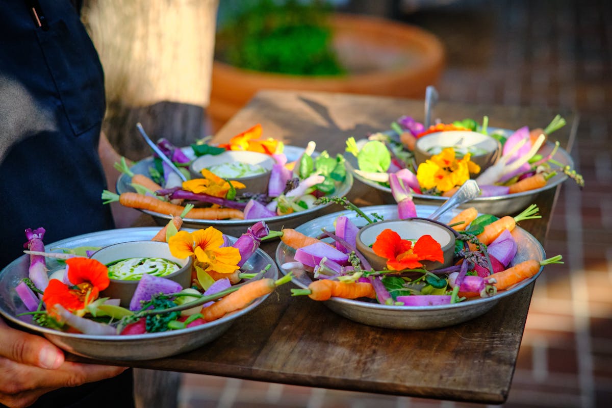 plates of charter oak crudite with edible and colorful flowers