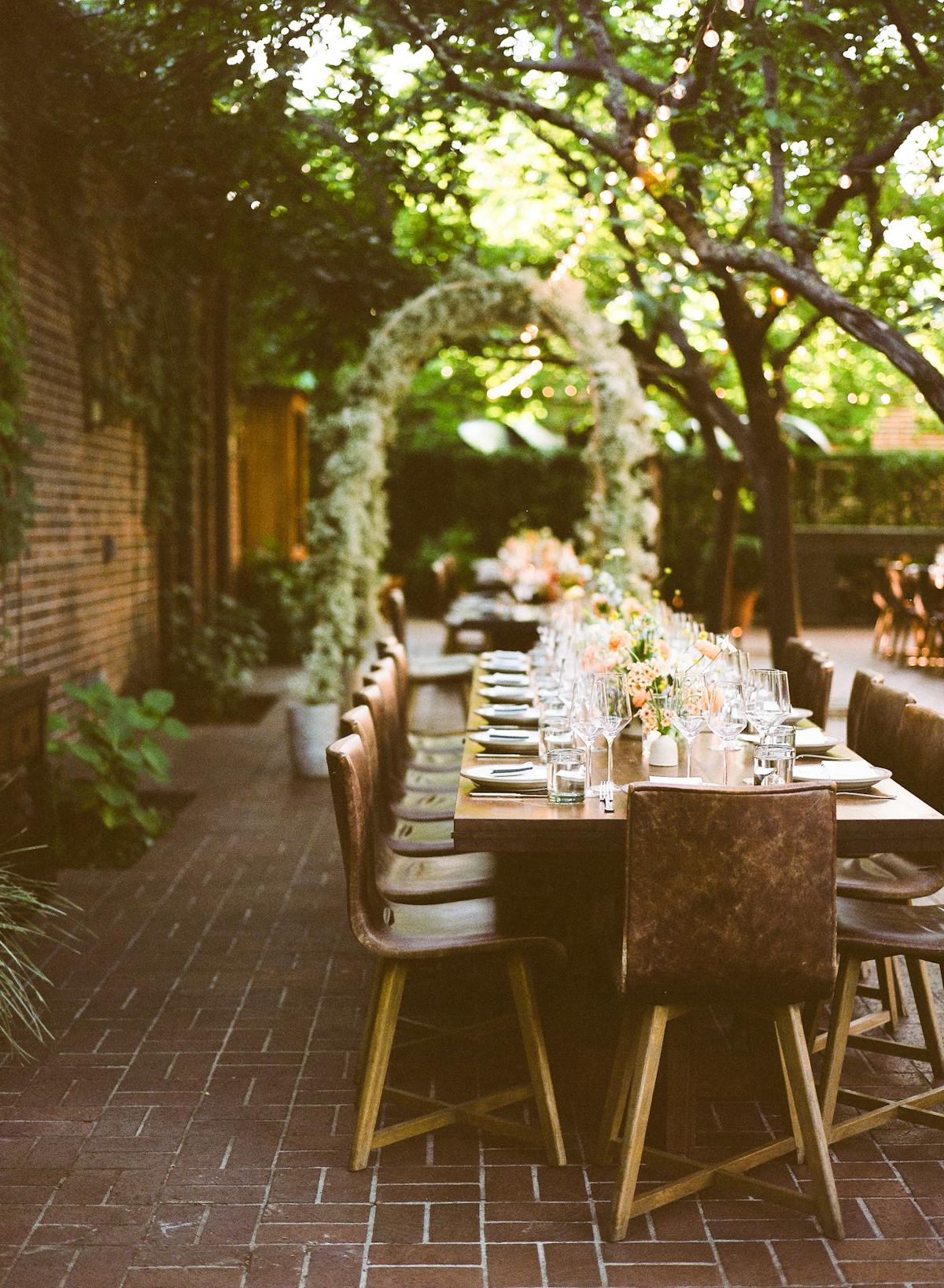 a room filled with furniture and vase of flowers sitting on a bench