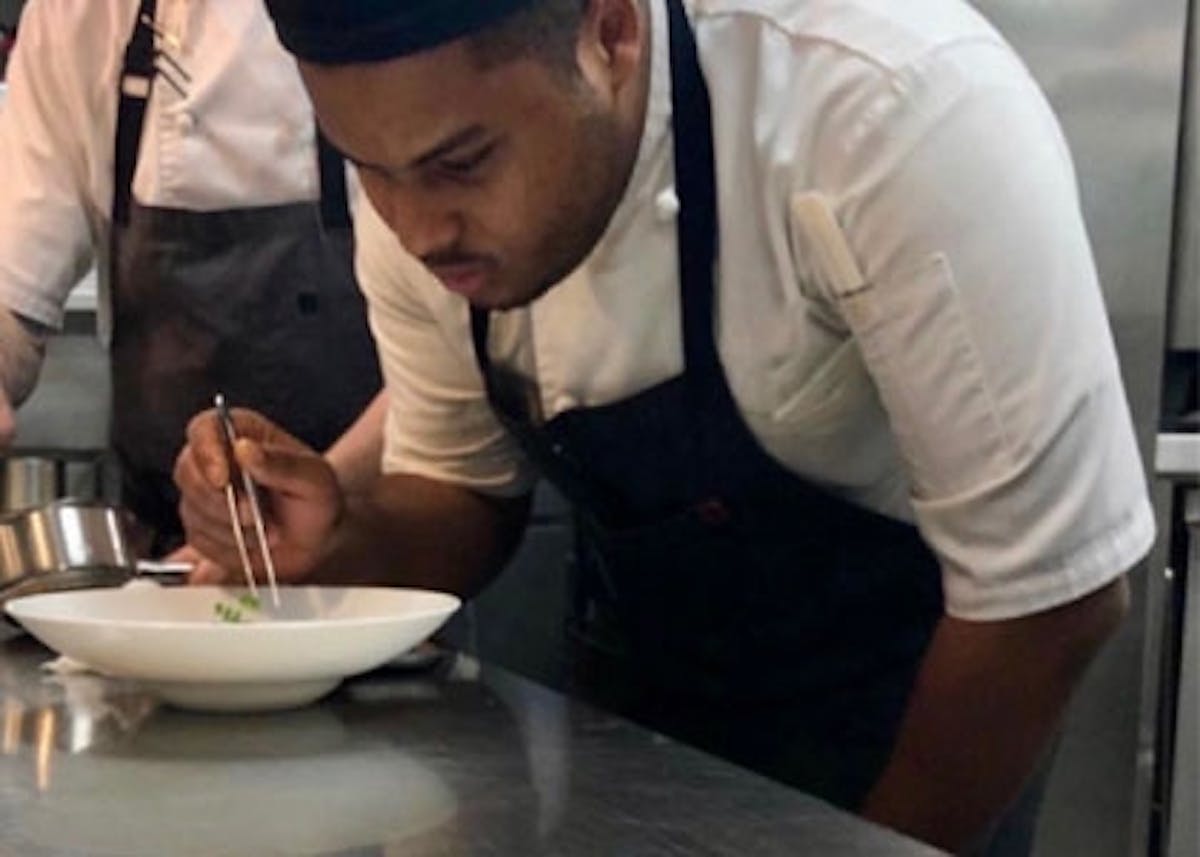 a man sitting at a table with a bowl of food