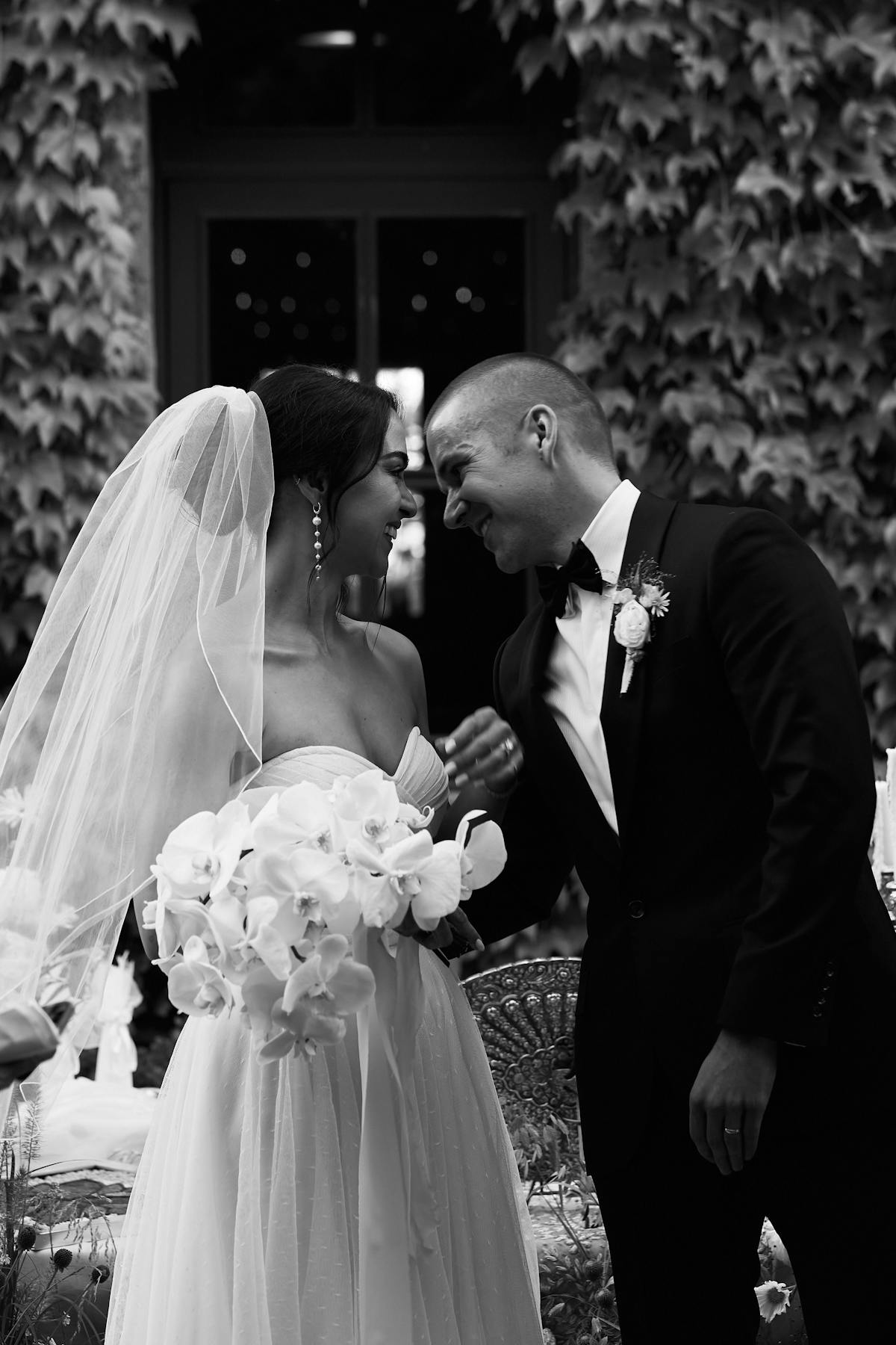 a bride and groom smiling in the charter oak courtyard
