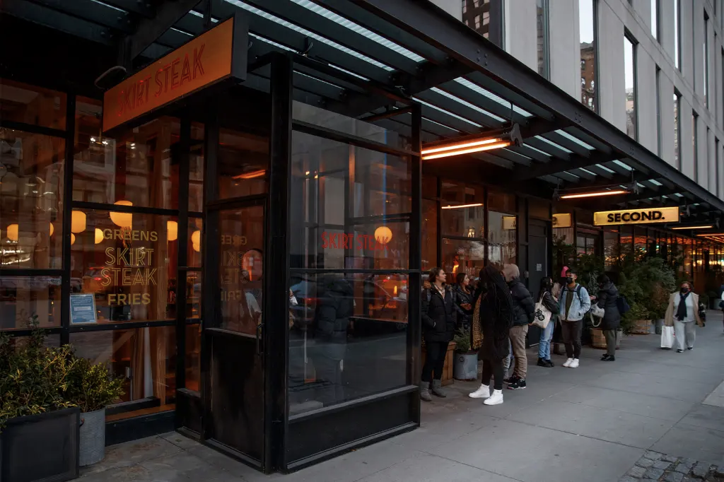 a group of people outside a restaurant