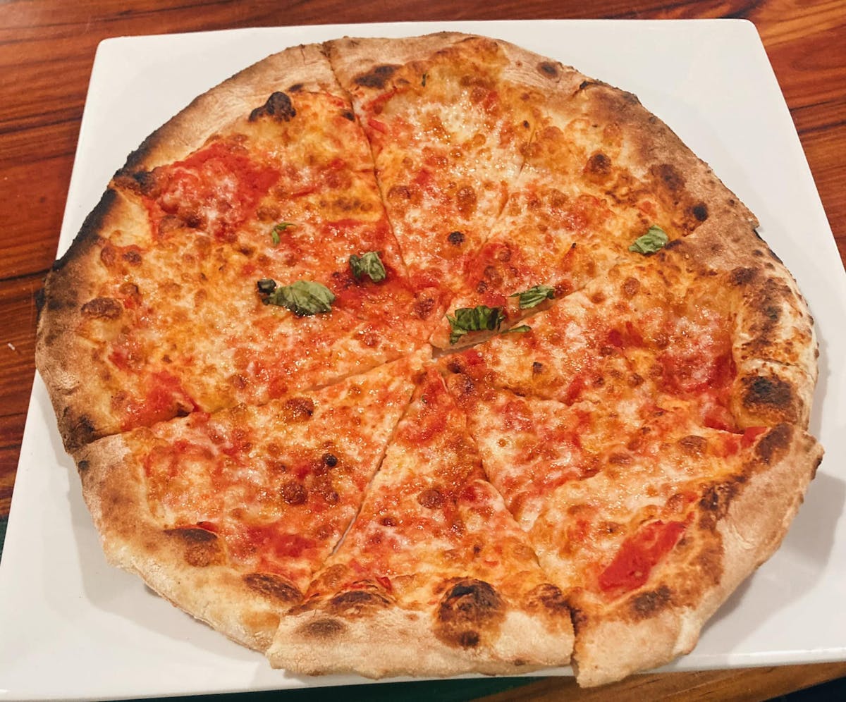 a pizza sitting on top of a wooden table