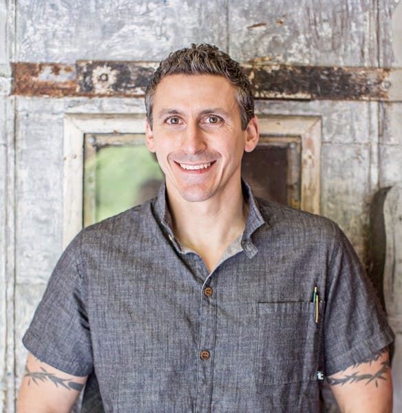 headshot of chef in grey collared shirt