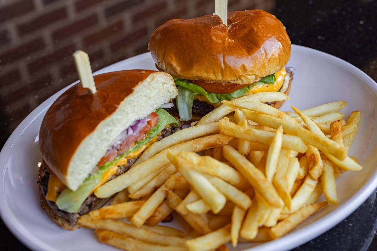 a close up of a sandwich and fries on a plate