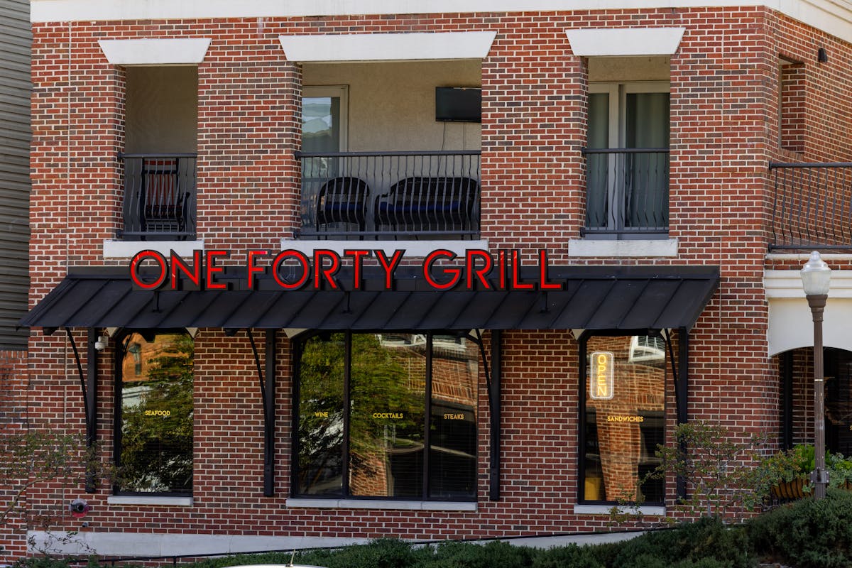 a sign in front of a brick building